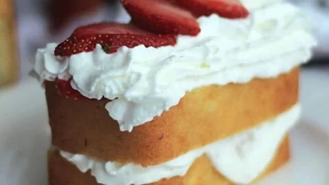 Low carb keto strawberry shortcake topped with fresh strawberries and whipped cream.