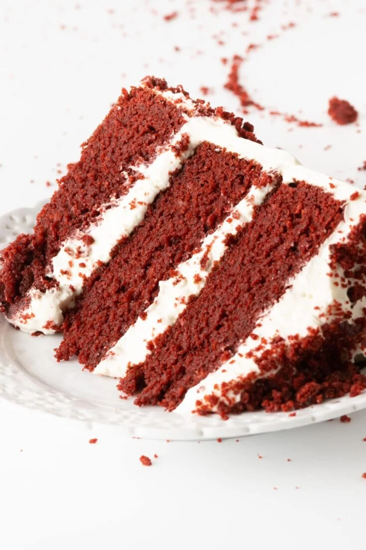 Delicious low carb red velvet cake with cream cheese frosting on a white plate