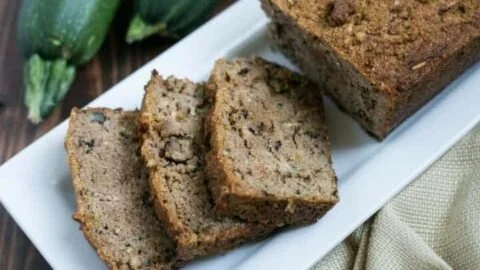 Slice of low carb gluten free zucchini bread on a wooden table