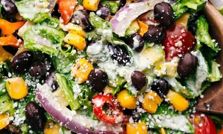 Colorful and fresh Mexican Salad with vegetables and vinaigrette dressing.