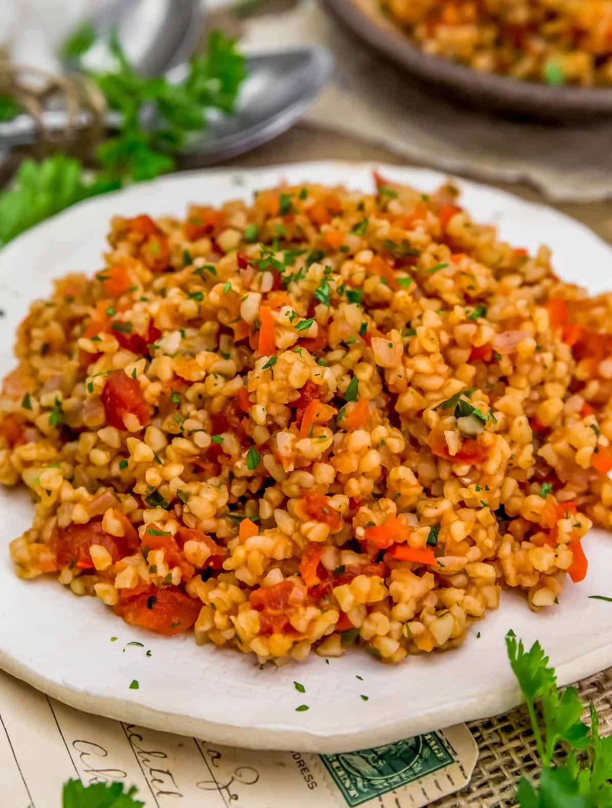 Bowl of Middle Eastern bulgur pilaf garnished with herbs and spices