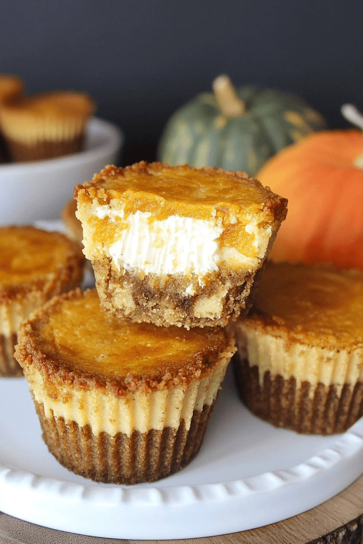 Mini pumpkin cheesecakes on a serving platter, perfect for fall desserts