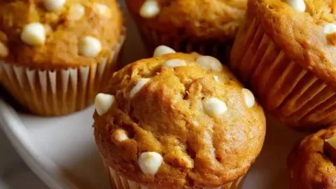 Moist pumpkin muffins with white chocolate chips fresh from the oven