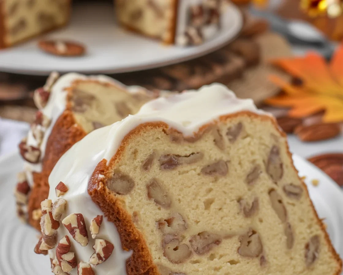 Homemade Butter Pecan Pound Cake with chopped pecans and creamy frosting.