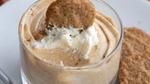 No Bake Keto Pumpkin Cheesecake topped with whipped cream and pumpkin spice