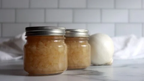 Jar of homemade onion relish showcasing its rich color and texture.