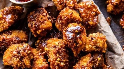 Oven Fried Southern Hot Honey Popcorn Chicken served on a plate with dipping sauce.