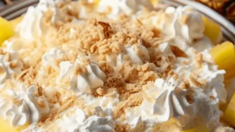 Delicious Pineapple Paradise Fluff dessert in a bowl topped with fresh pineapple