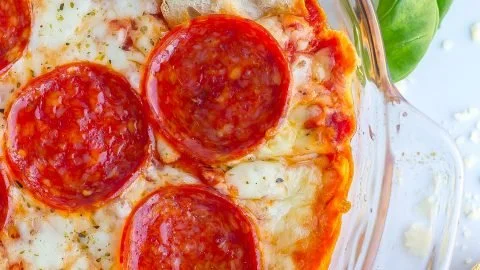 Delicious homemade Pizza Dip served in a bowl with toppings