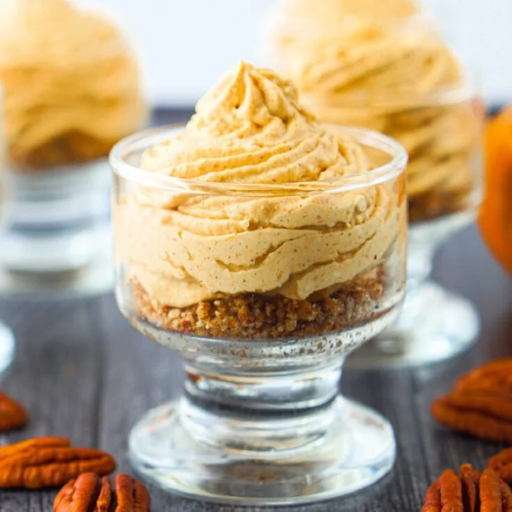 Delicious Pumpkin Keto No-Bake Cheesecake slice topped with whipped cream