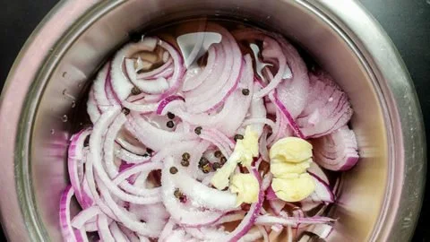 Quick and zesty pickled red onions in a jar, ready to serve.