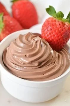 Delicious quick keto chocolate mousse in a glass, topped with whipped cream.