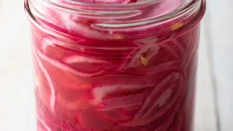 Quick pickled red onions in a jar ready for serving