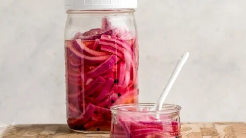 Jar of quick pickled red onions ready to enhance your meals