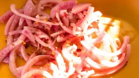 Jar of quick pickled red onions perfect for topping on various dishes