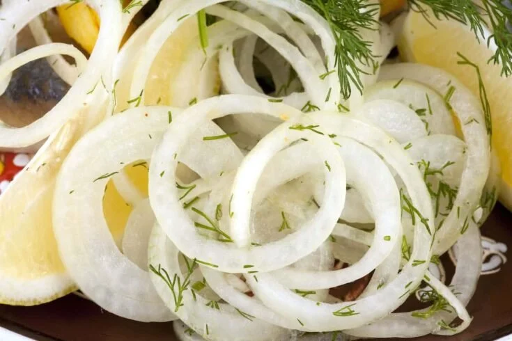 Quick pickled white onions in a jar, ready to serve as a condiment.