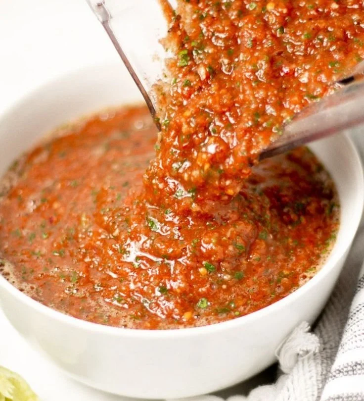 Homemade restaurant style salsa in a bowl with ingredients
