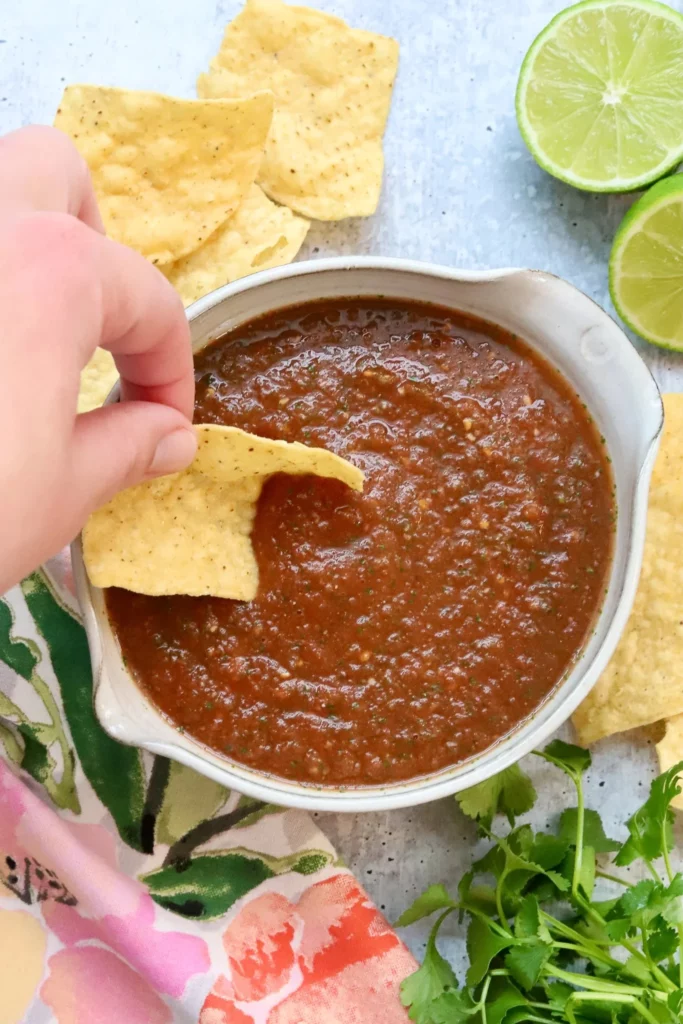 A bowl of fresh restaurant-style salsa with vibrant tomatoes, onions, and cilantro.