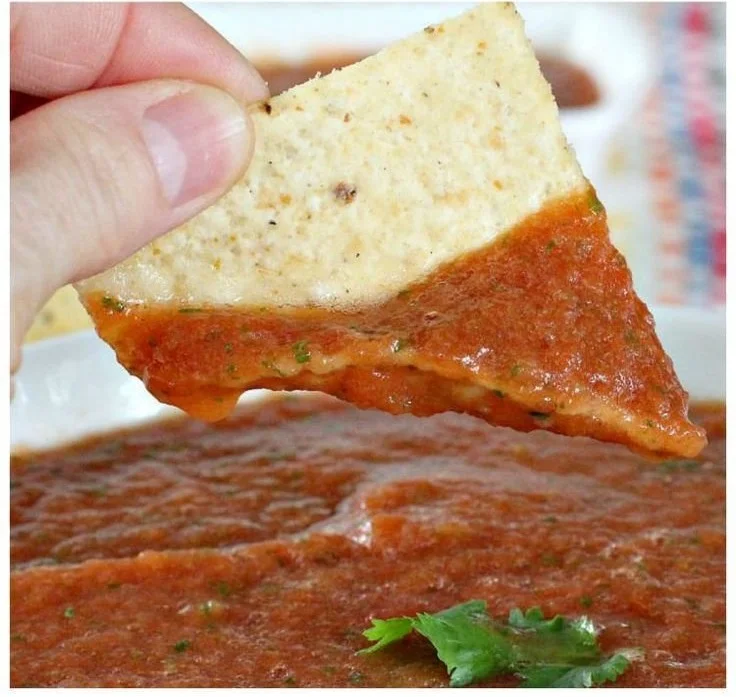 Bowl of vibrant restaurant-style salsa with fresh ingredients and herbs