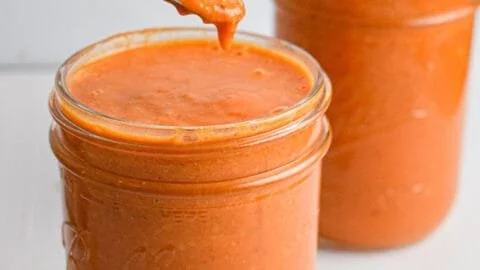 Delicious roasted cherry tomato sauce in a bowl, perfect for pasta dishes.