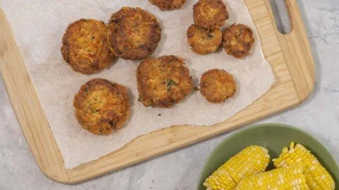 Golden brown salmon patties served with a side of fresh salad