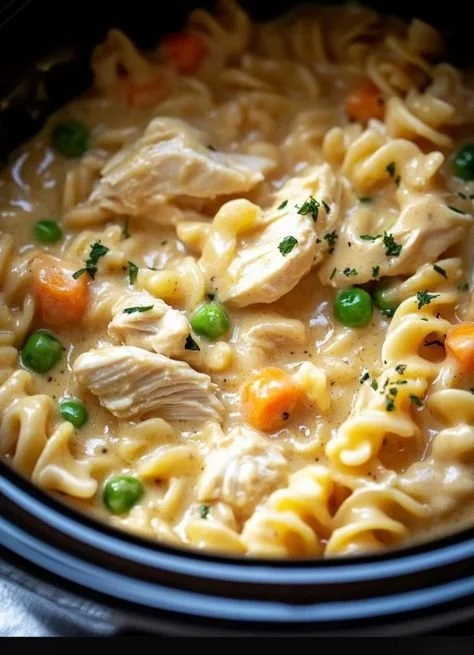 Delicious Slow Cooker Chicken Pot Pie Pasta topped with fresh herbs in a bowl