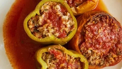 Delicious slow cooker stuffed peppers served on a plate with toppings.