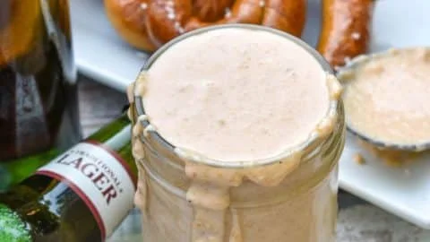 Delicious smoked beer cheese dip served with crispy bread and pretzels