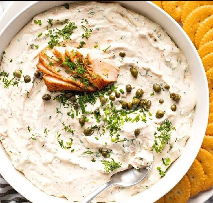 Delicious smoked salmon dip served with crackers and fresh herbs