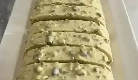 Smooth white chocolate pistachio cookies freshly baked and served on a plate