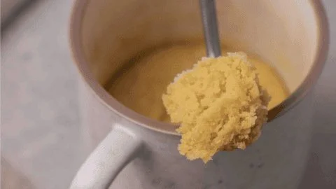 Soft and chewy sugar cookie baked in a mug with sprinkles on top