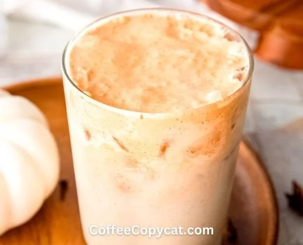Homemade iced pumpkin cream chai tea latte in a glass with fall spices