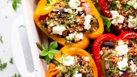 Stuffed peppers filled with quinoa and assorted vegetables on a plate