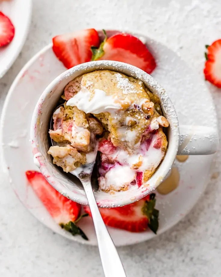 Delicious keto strawberries and cream mug cake in a white mug