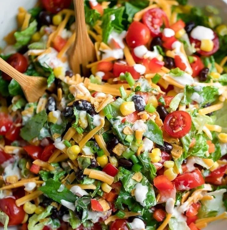 Colorful vegetarian black bean taco salad with toppings