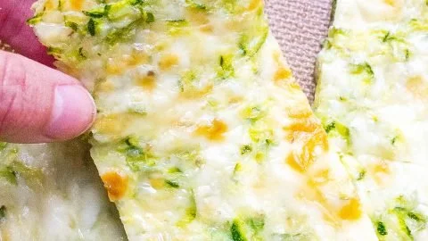 Freshly baked Zucchini Cheese Bread with melted cheese and zucchini slices