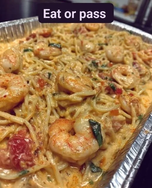 Creamy Cajun shrimp pasta bake topped with herbs and spices.