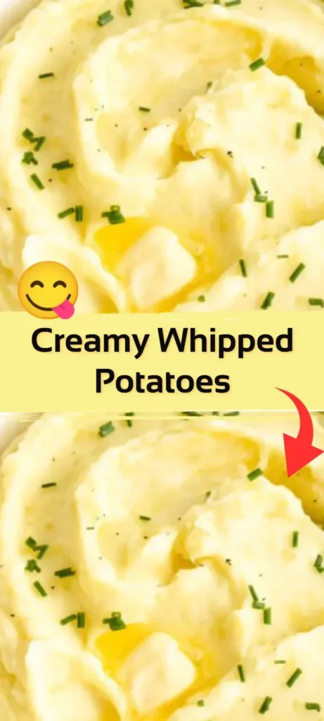 Creamy whipped potatoes served in a bowl, garnished with herbs.