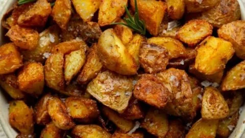 Crispiest oven roasted potatoes served on a plate
