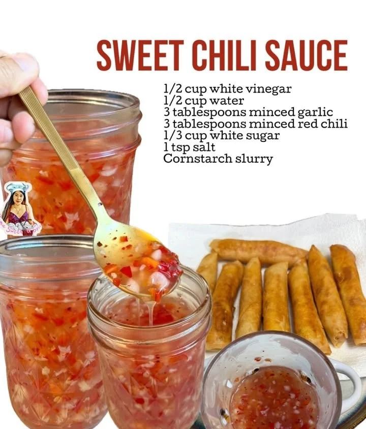 A jar of homemade sweet chili sauce with fresh chili peppers and garlic.