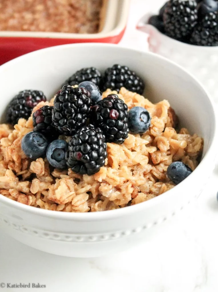 Maple and brown sugar baked oatmeal served in a bowl, topped with fresh berries.