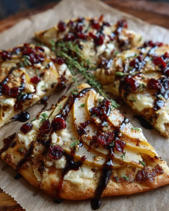 Pear, Brie, and Cranberry Flatbread topped with fig jam and balsamic glaze