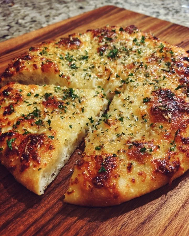 Roasted garlic herb flatbread sprinkled with Parmesan cheese