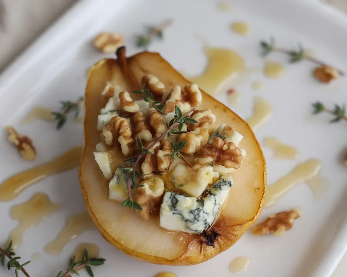 Baked pears with berries, honey, walnuts, and blue cheese for a delicious dessert