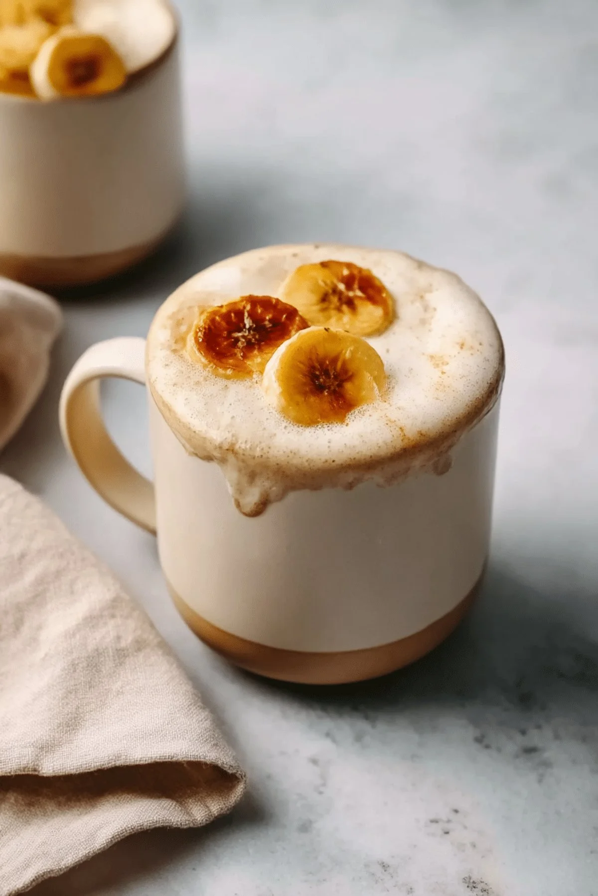 Delicious homemade banana bread latte in a cozy mug with a sprinkle of cinnamon.