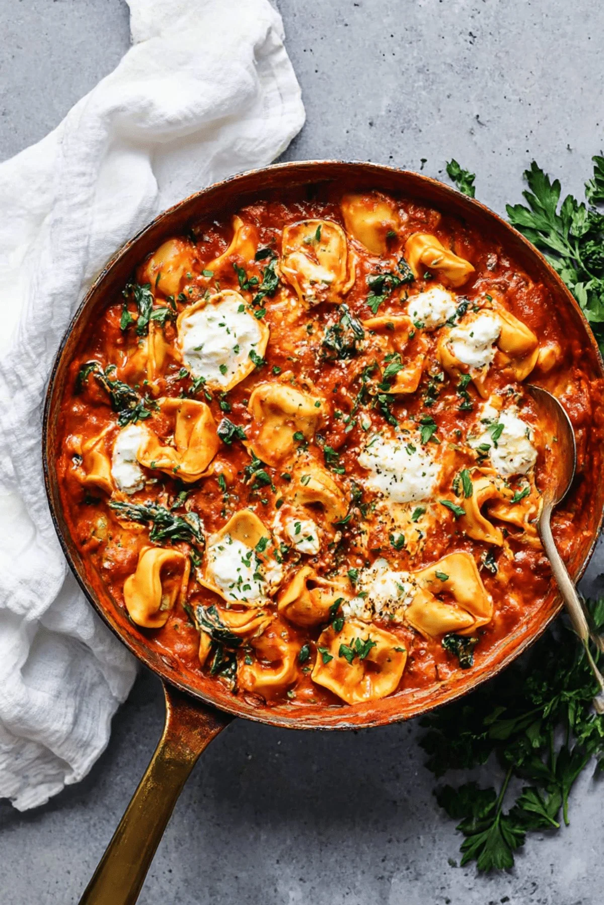 Bowl of Cheese Tortellini in Creamy Marinara sauce, garnished with basil