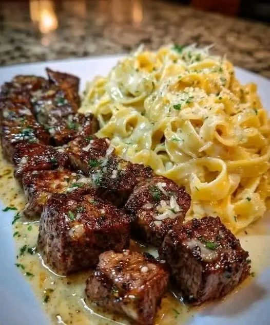 Creamy garlic butter chicken served with linguine in Alfredo sauce