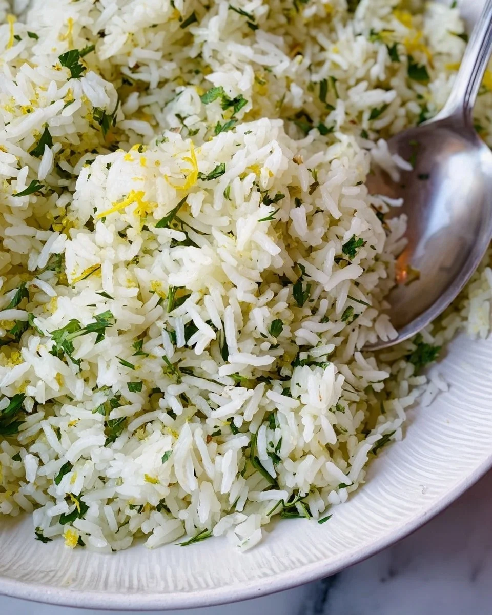 Bowl of Greek Lemon Dill Rice garnished with fresh dill and lemon slices