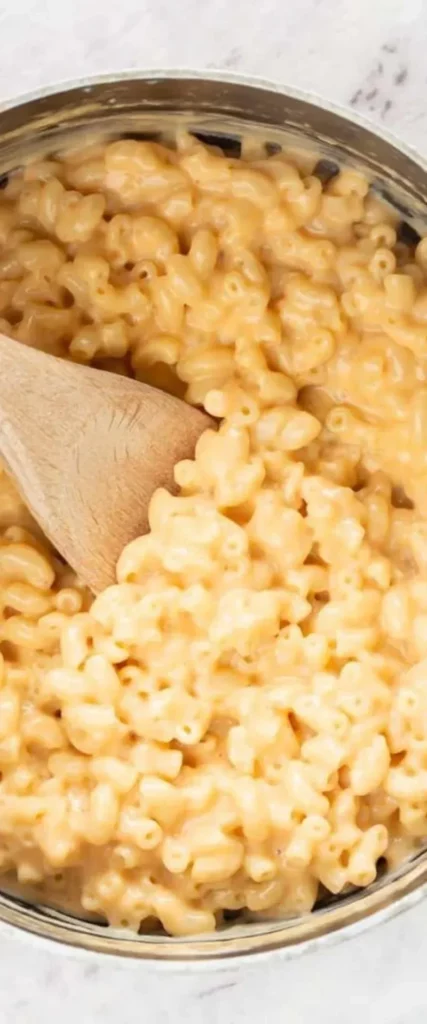 Bowl of low carb cheesy mac and cheese topped with herbs and cheese