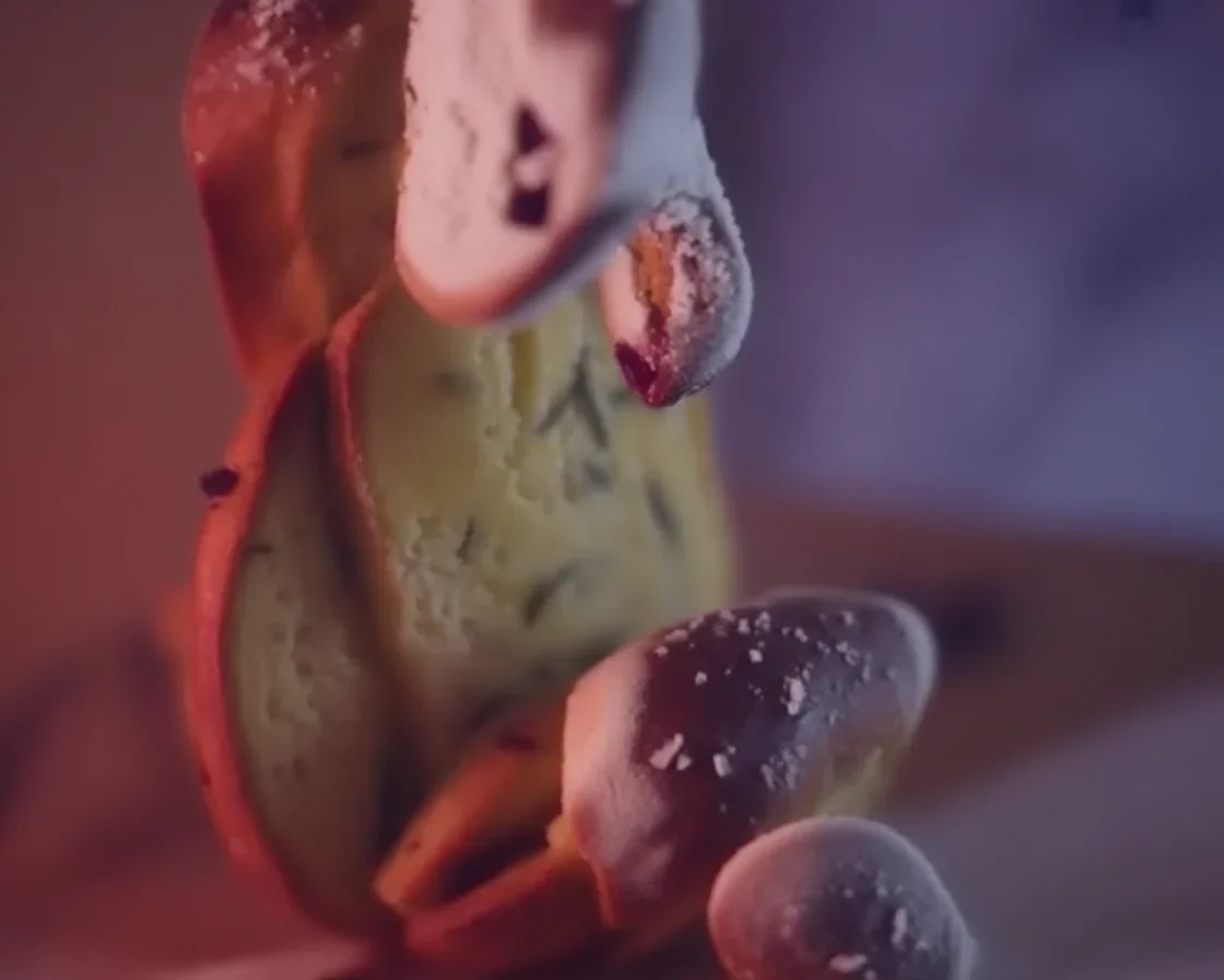 Loaf of no-knead rosemary cranberry bread with olive oil and sea salt.